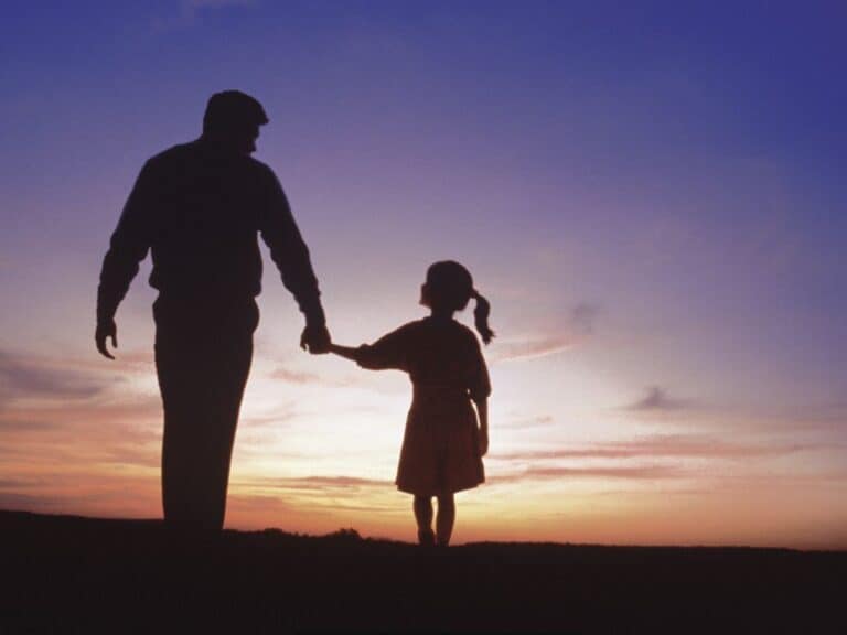 God Longs To Be Close To You Silhouette of a father and daughter walking into a sunset.